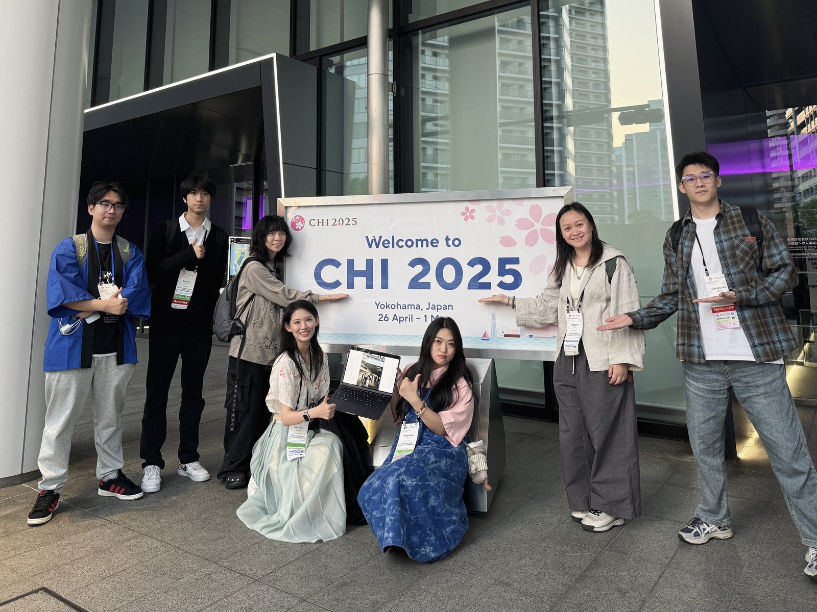 Conference attendees beside the CHI 2025 sign in Yokohama.